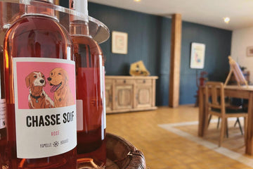 Vue rapprochée d'un présentoir de bouteilles de Chasse Soif avec la salle de dégustation en arrière plan